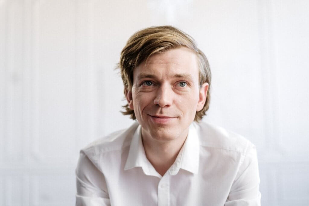 man in white dress shirt smiling
